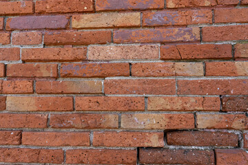 Obraz premium Old Red Brick Wall Texture Background. High quality photo. Close up view of an old red brick wall with visible cracks and weathered texture. The worn surface and natural imperfections create a rustic