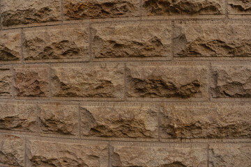 Textured Brown Stone Brick Wall Close-Up. High quality photo. Close up view of a rough textured...