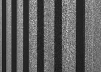 Corrugated metal sheet surface with diagonal ridges, showing detailed texture and pattern commonly...