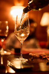 Pouring champagne into elegant  glass	
