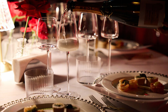Pouring champagne into elegant  glass	