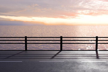 夕日がキラキラ海面に反射するガードレールがある海沿いの道
