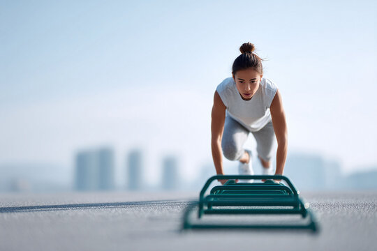 Determined woman focused on agility training with hurdles. Concept Fitness, strength, motivation, and healthy lifestyle. Great for sports, and wellness.