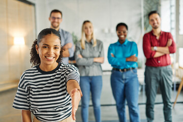 Portrait of a young businesswoman and group of young businesspeople wecoming and offering a handshake