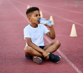 Children running on track at the stadium, practice during sports class in school training , little...