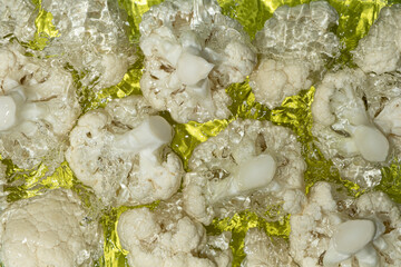 Overhead View of Cauliflower in Water with Splash.