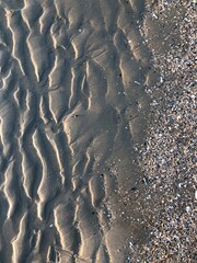 gray beach wavy sand ripples dune texture wallpaper pattern background close-up