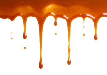 Caramel sauce dripping against a black background creating a sweet and delicious visual texture effect