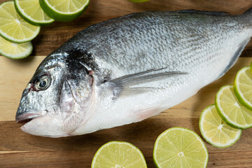 Fresh Raw Dorado Sea Bream Fish with Lime Slices