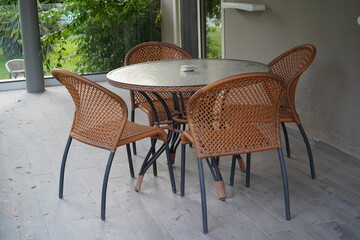 Cozy outdoor space with a round table and woven chairs perfect for afternoon tea or quiet conversations in a serene garden setting