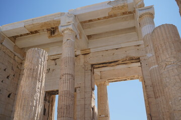 Ancient columns stand tall under a clear blue sky at a historic site filled with echoes of the past and stories waiting to be told
