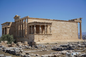 Ancient architecture stands proud under the clear blue sky in Athens, showcasing the rich heritage...