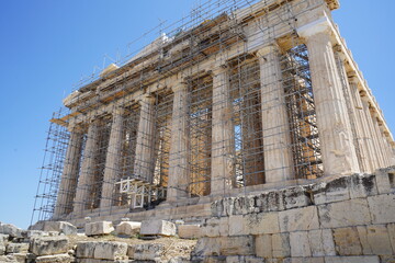 Construction restoration of the Parthenon on the Acropolis in Athens showcases ancient architecture against a clear blue sky
