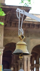 Close-up of a large temple bell in Govardhan, Uttar Pradesh, India — highlighting traditional...