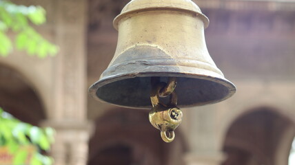 Close-up of a large temple bell in Govardhan, Uttar Pradesh, India — highlighting traditional...