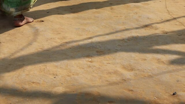 Devotees walking barefoot during Govardhan Parikrama on Guru Purnima, only feet visible in the frame, capturing spiritual devotion and traditional ritual in rural India