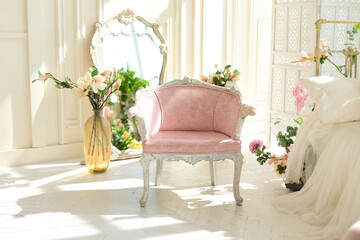Pink velvet padded armchair with wooden legs in classic bedroom. Shabby chic interior girly or provencal style with pink chair. Wedding interior room. Princess design room furniture. 
