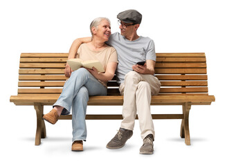 Happy Mature couple sitting closely together on a wooden bench, embracing while the woman reads a book and the man uses a smartphone. Studio image isolated on white background