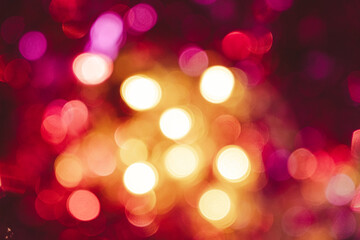 Obraz premium Festive blurred Christmas background, shining pink and yellow lights