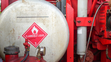 Flammable liquid warning information sign on the gasoline or diesel fuel tank for standard use in...