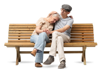 Mature couple sitting on a wooden bench, the man comforting his partner who appears sad or distressed. He embraces her with care, offering emotional support. Studio shot isolated on white background.