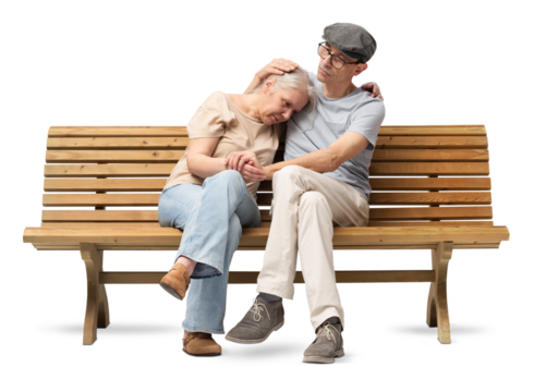 Mature couple sitting on a wooden bench, the man comforting his partner who appears sad or distressed. He embraces her with care, offering emotional support. Studio shot isolated on white background.