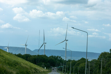a modern wind farm featuring multiple towering wind turbines set against a backdrop of rolling...