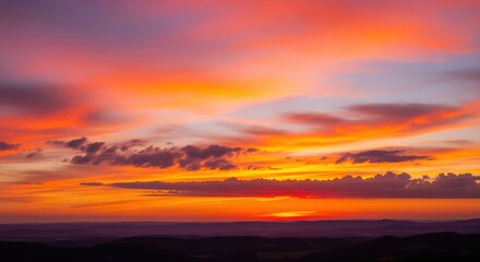 Fiery Sunset Over Distant Hills and Cloudscape