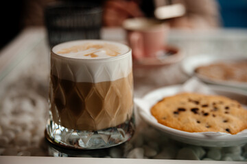 coffee latte in a glass with cookies
