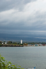 Fototapeta premium Sumba, Indonesia – 07. 04. 2025 – It's still daytime, but the weather is cloudy. Two seaports in Waingapu are visible in a single view, with small and large ships moored around them