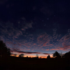 Fototapeta premium The sky is dark and cloudy with a few stars visible