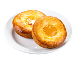 Freshly baked golden pastries with a vibrant fruit center present a delightful breakfast or dessert.