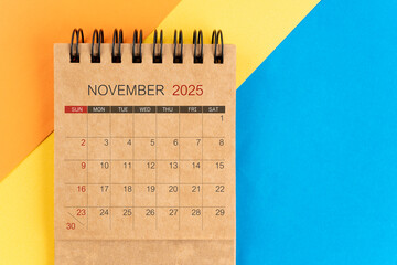November 2025 brown mini calendar on colorful background.