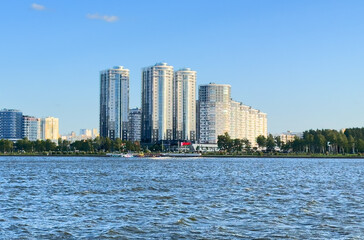 City near lake at sunset. Downtown Minsk and Lake Drozdy. Long Panoramic River Downtown City Skyline. Panarama of City with buildings and  houses on waterfront. buildings and downtown city skyline