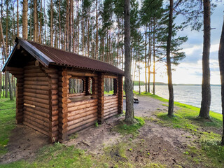 Summerhouse for rent on vacation at sea. Wooden house for recreation in nature. Camping area with Wooden gazebo for rest on river. Wooden Arbour for camping. Timber Wood Pavilion in forest at lake.