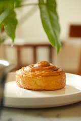 A delicious variety of gourmet puff pastry cinnamon rolls, served on white plate.A plate of...