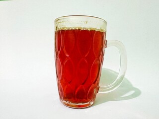 Cold turmeric drink, glass cup of turmeric drink. Glass of healthy turmeric drink on white background. Turmeric drink made from spices and can be used as medicine.
