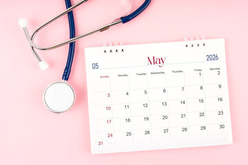 Blank May 2026 desk calendar and stethoscope, Medical appointment schedule to check up.