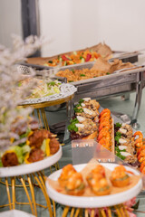 A colorful and delicious buffet spread featuring a wide variety of international dishes, including fizzy cola, lemon tart, creamy cheesecake, blueberry tart, crispy fried chicken, and savory pasta