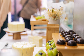 A colorful and delicious buffet spread featuring a wide variety of international dishes, including fizzy cola, lemon tart, creamy cheesecake, blueberry tart, crispy fried chicken, and savory pasta