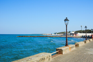 Touristic promenade and blue sea at San Cataldo coast, in Salento, Lecce, Apulia Region, Italy 