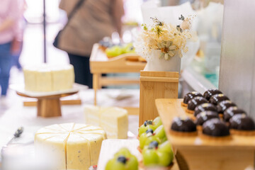A colorful and delicious buffet spread featuring a wide variety of international dishes, including fizzy cola, lemon tart, creamy cheesecake, blueberry tart, crispy fried chicken, and savory pasta