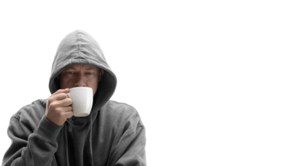 A person in a hoodie enjoying a warm beverage, isolated on a white background.
