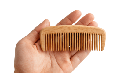A hand holding a wooden comb on a white isolated background, symbolizing grooming and personal care.
