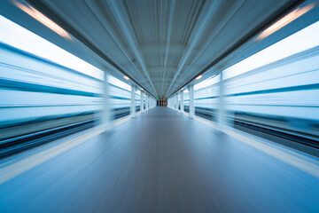 Abstract motion blur perspective of a modern enclosed pedestrian walkway