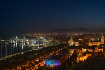 Sparkling Malaga Port and Illuminated Cityscape at Night

An enchanting night view of Malaga's illuminated port, featuring the glowing lighthouse, bustling promenade, and a vibrant city a