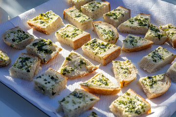 Close-up of small homemade bread slices topped with creamy wild garlic butter.