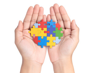 A pair of hands cradles a colorful heart puzzle, representing connection and shared support.
