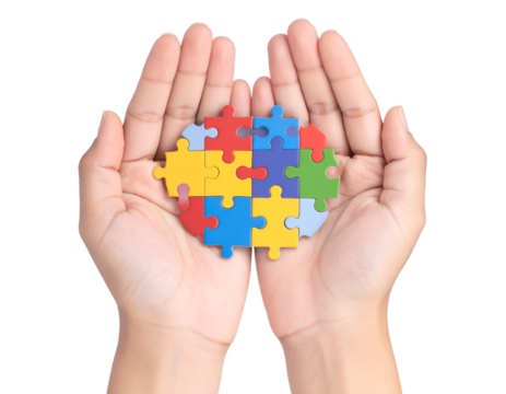 A pair of hands cradles a colorful heart puzzle, representing connection and shared support.