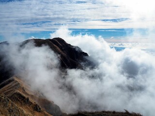 a sea of ​​clouds arriving over the mountain ridge